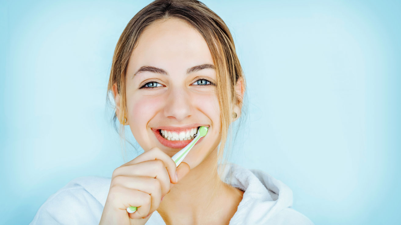 Girl brushing her teeth.